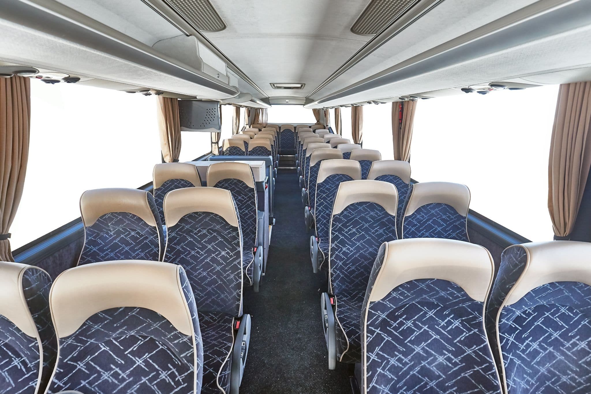 A group of people happily boarding a charter bus