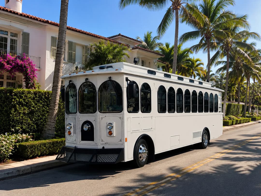 White Rent A Trolley trolley outside a Mediterranean-style estate, available for Palm Beach island weddings and private events