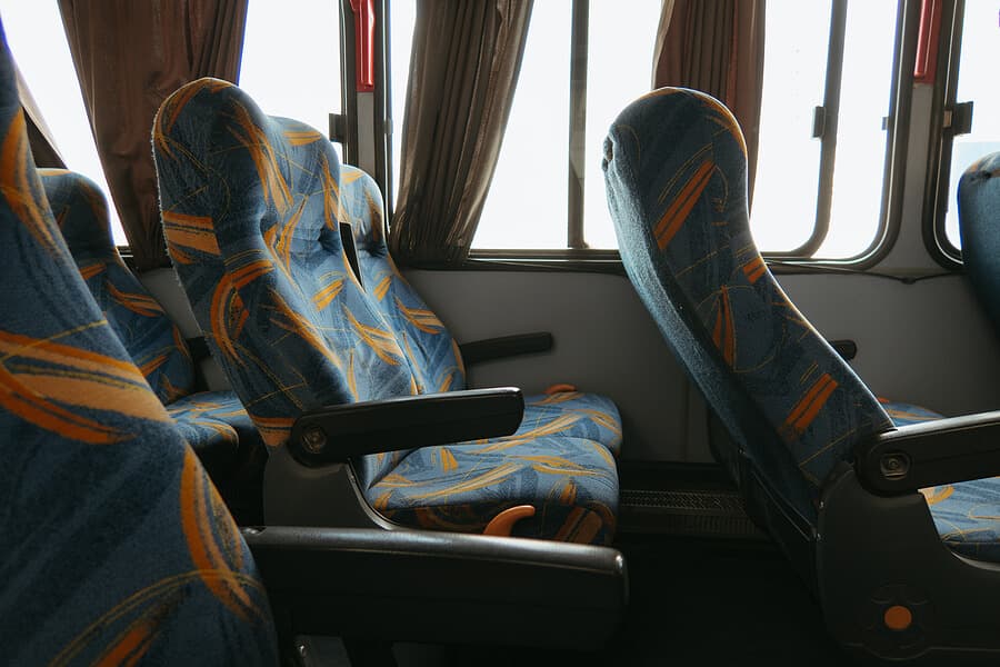 Inside a charter bus showing reclining seats